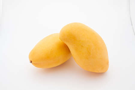 Close up one ripe yellow mango popular of fruit slices product isolated mockup on white background concept for summer tropical juice taste breakfast image. Eating fresh healthy organic food.の写真素材