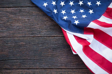 America flag waving pattern on wooden background in table top view, red blue white strip concept for USA 4th july independence day, symbol of patriot freedom and democracy. Glory pride in memorial day of libertyの写真素材