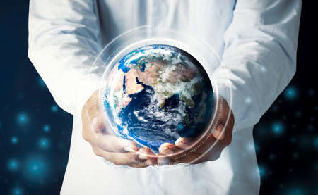 Businessman hand holding multinational hologram globe concept for world map responsibility, cloud internet network connection, international tech information, global education classroom online, CSR earth ecosystemの写真素材