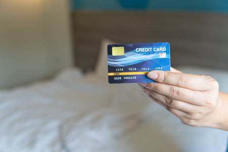 Business woman hand hold credit card to shopping internet online bill on computer, Debit saving...