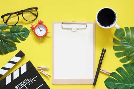 Vintage red clock in coffee time on filmmaker office table top view concept blank empty workspace mockup display, vlog stay and work at home for movie clip ideaの写真素材