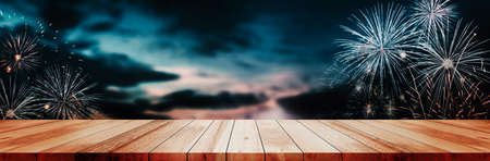 Panoramic empty clean wood counter table top on blur firework celebration night cafe background use for pub party montage dark scene, Wooden texture shelf bar in luxury restaurant backdrop mockupの写真素材