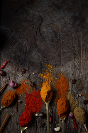 Condiment of indian food Spice garnish background on wood table top view. Seasoning of Asian organic herb cuisine flavour in kitchen board, chilli spicy taste conceptの写真素材