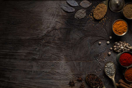 Condiment of indian food Spice garnish background on wood table top view. Seasoning of Asian organic herb cuisine flavour in kitchen board, chilli spicy taste conceptの写真素材