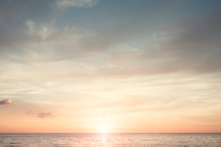 Sunset beach sky background concept, sunrise colors clouds, horizon dawn sunlight.の写真素材