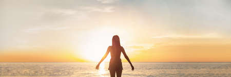 Silhouette woman with hands rise up on beautiful view. Christian praise on hill thanksgiving day background. support nature standing open arms enjoying sun concept jesus fun world wisdom 2021の写真素材
