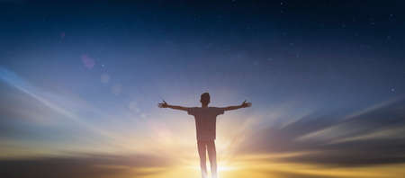 Happy man rise hand Worship God in morning view. Christian spirit prayer praise on good friday background. Male self confidence empowerment on mission arm concept strength wisdom ambitiousの写真素材