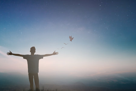 Happy man rise hand Worship God in morning view. Christian spirit prayer praise on good friday background. Male self confidence empowerment on mission arm concept strength wisdom ambitiousの写真素材