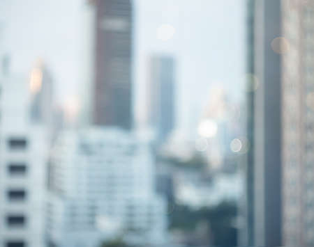 Abstract blur city estate building in morning view background. Cityscape skyline from top office window view. Blurred shine bokeh real architecture modern company construction town outdoor.の写真素材