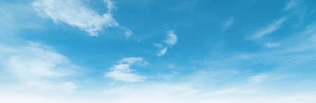 Summer Blue Sky and white clouds background. Beautiful clear cloudy in sunlight spring season. Panorama vivid cyan cloudscape in nature environment. Outdoor horizon skyline with spring sunshine.の写真素材