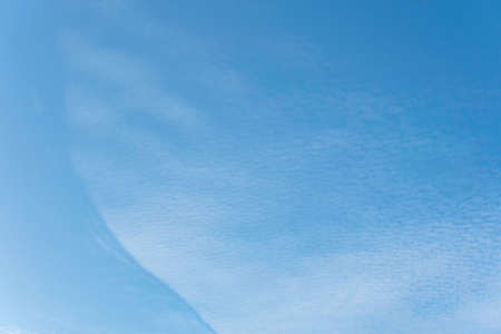 Summer Blue Sky and white clouds background. Beautiful clear cloudy in sunlight spring season. Panorama vivid cyan cloudscape in nature environment. Outdoor horizon skyline with spring sunshine.の写真素材