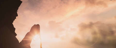 Silhouette of Jesus with Cross over sunset concept for religion, worship, Christmas, Easter, Redeemer Thanksgiving prayer and praiseの写真素材