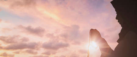Silhouette Young muslim woman hijab honesty pray to God on sunset panoramic mosque background concept for eid mubarak, life and spiritual of islam girl fasting in ramadan, Indonesian civilian peopleの写真素材