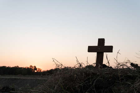 Silhouette jesus christ crucifix on cross on calvary sunset background concept for good friday he is risen in easter day, good friday worship in God, Christian praying in holy spirit religious.の写真素材