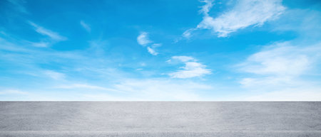 Panoramic empty grunge cement counter table top on blue sky white light bokeh background for product morning scene spring display montage, Abstract Blurry wide concrete desk in kitchen resort hotel.の写真素材
