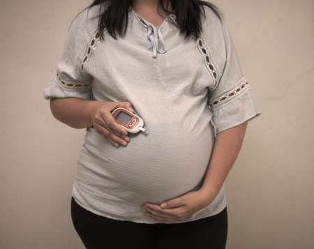 Pregnant woman checkup blood control risk sugar level for gestational. Female pregnancy health glucose measurement meter concept for glucometer, medicine, glycemia, health care. World Diabetes day.の写真素材