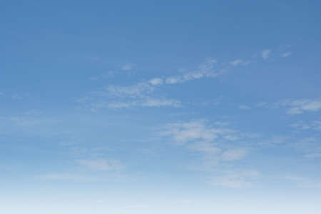 Summer Blue Sky and white clouds background. Beautiful clear cloudy in sunlight spring season. Panorama vivid cyan cloudscape in nature environment. Outdoor horizon skyline with spring sunshine.の写真素材