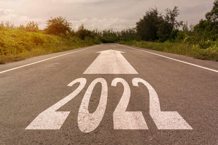 Happy New Year 2022 white text numbers up arrow on road  background color concept for confetti on morning view. on start business in trend 2022の写真素材