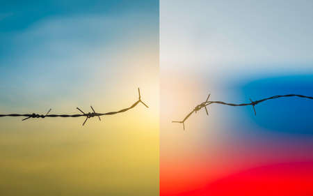 Barbed wire fence with sunset Twilight sky. Chain spike for world war safe security boundary concept for human rights slave, prison hostage hope to peace. International liberty day. russia ukraineの写真素材