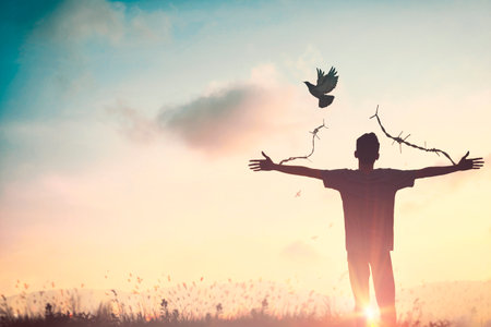 Happy man rise hand Worship God in morning view. Christian spirit prayer praise on good friday background. Male self confidence empowerment on mission arm concept strength wisdom ambitiousの写真素材