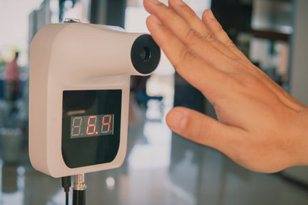 Digital device temperature measurement precision, safety and reliability in medical monitoring. Sensors automation data analysis for health and infection control in schools, shops, and restaurants.の写真素材