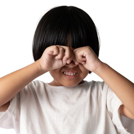 cry child girl short hair white t-shirt showing cute smile, young kid adorable cheerful innocent joyful emotion face portrait, playful expression bright happiness purity backgroundの写真素材