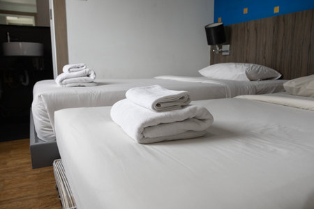 Bright clean comfortable bedroom interior white bed linen bedding soft pillows plush duvet light window contemporary design home comfort hotel apartment space.の写真素材