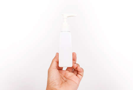 Man hand holding a cream tube,pump cream on white backgroundの写真素材