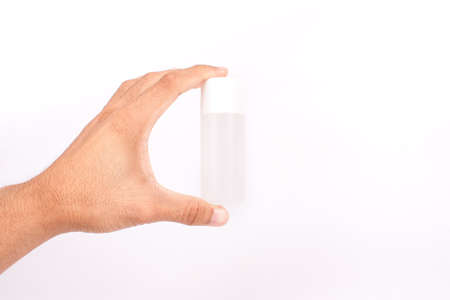 Man hand holding a small tube cream on white backgroundの写真素材
