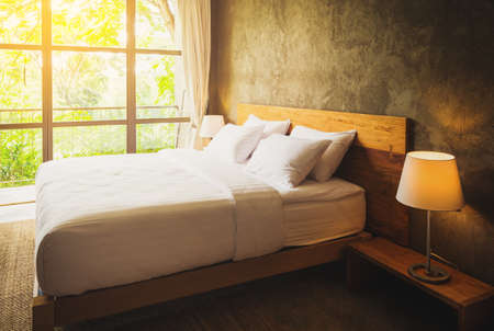 close up Bedroom Suite interior with white pillows and wall concrete backgroundの写真素材