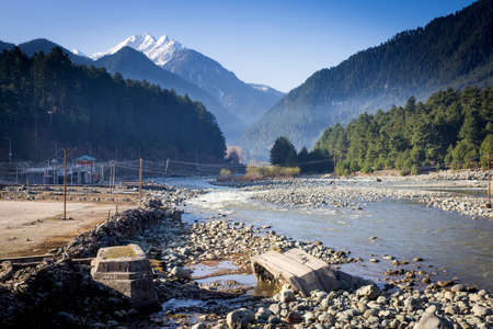 Panoramic view of beautiful mountain landscape small village among snow pine trees mountain backgroundの写真素材
