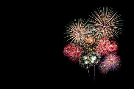 Festive patterned of Colorful assorted firework bursting in various shapes sparkling pictograms set against black background abstract の写真素材