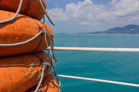 Lifeboats on ferry on a background of the islandの写真素材