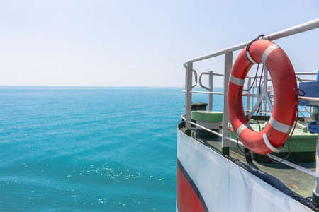 Lifebuoy hanging on the railing of the ferryの写真素材
