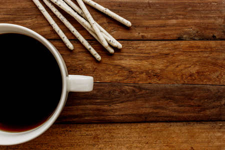 crispy sticks in white glaze and black coffeeの写真素材