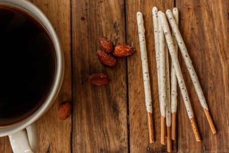 Crispy sticks with white chocolate and almonds complement delicious coffeeの写真素材