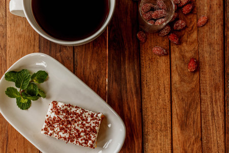 Delicious cheesecake with mint on a wooden tableの写真素材