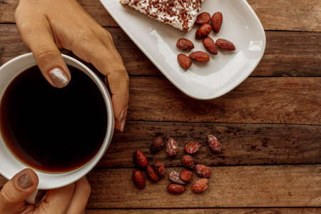 Morning thoughts over a mug of coffee on a wooden tableの写真素材