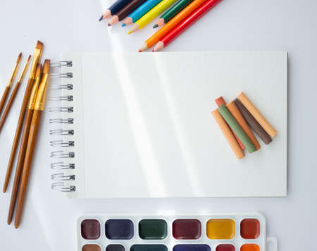 album for drawing, watercolor paints, brushes, pastels on a white background with space for text. creation .の写真素材