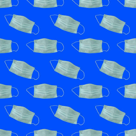 Many medical masks on the blu colored background to cover the mouth and nose for protection from virus and bacteria on a blu background. Epidemic concept. Regular pattern, flat lay.の写真素材