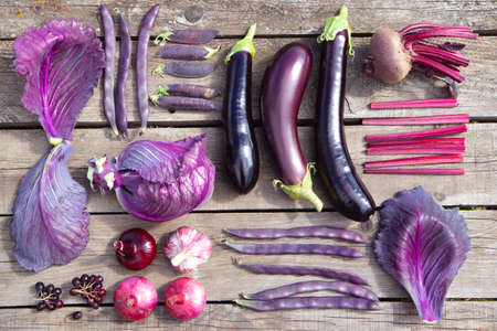 Purple vegetables in knoll style on natural old wooden background. Fashionable concept. Advertising, banner, poster.の写真素材
