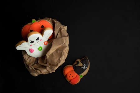 Halloween package with horror gingerbread cookies on black background with space for text.の写真素材