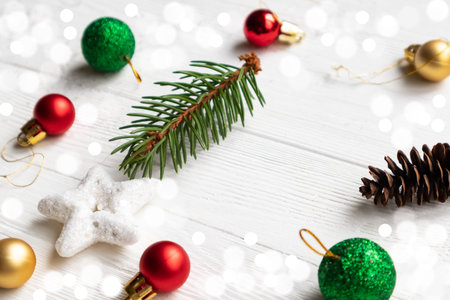 Multicolored Christmas balls and a fir sprig with a star on a white background with space for text....