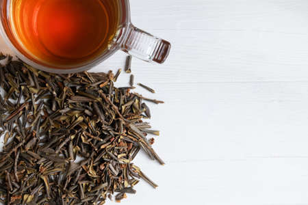 Sagan Daila tea leaves and a cup of tea on a white background with space for text.の写真素材