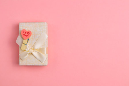 Pink box with a gift on a pink background with a place for text. Advertising.の写真素材