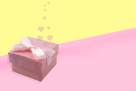 Pink box with a gift on a pink background with a place for text. Advertising, poster.