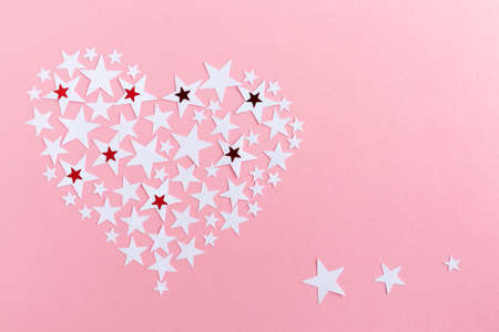 Heart made of stars on a pink background with space for text. Layout of a postcard, banner.の写真素材