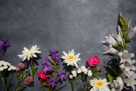 Flower arrangement on a gray background with space for text. Top view, flat layout. Postcard.の写真素材