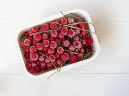 Frozen red and black currants in on a light background . The concept of preparing products for use...