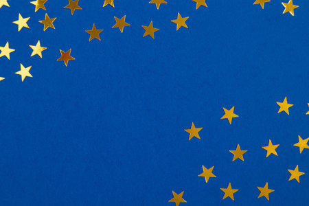 Blue background with golden stars with a place for text in the center. Banner, poster.